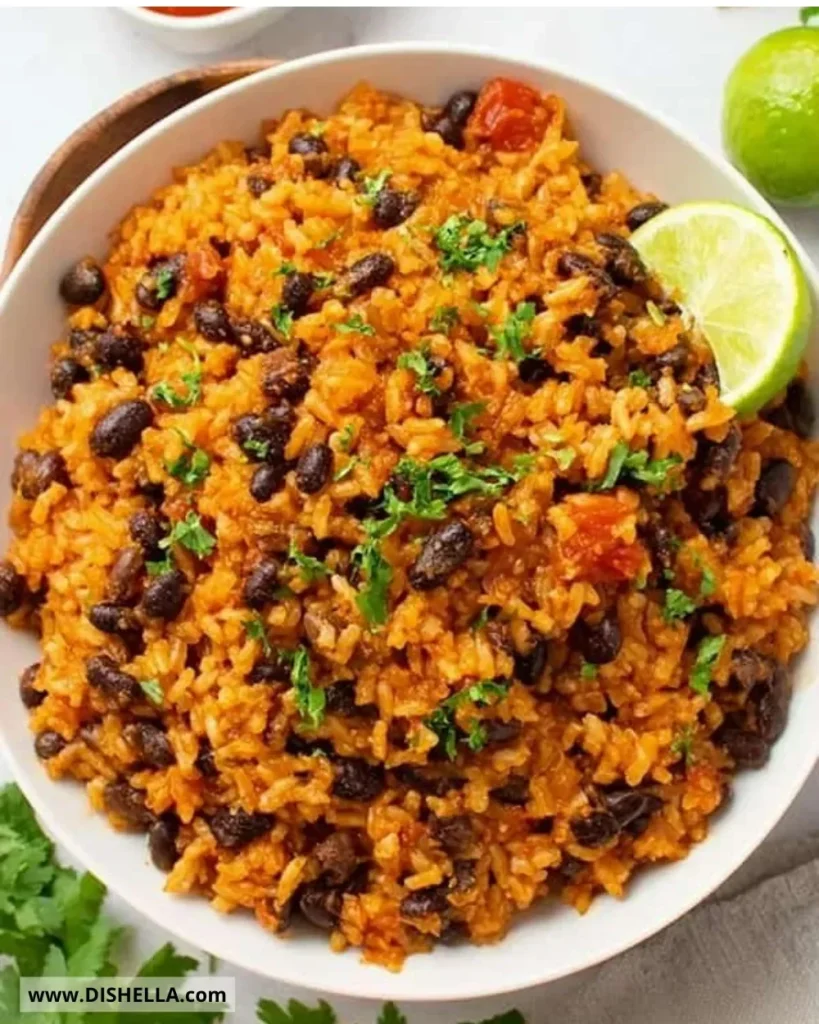 Delicious bowl of easy rice and beans garnished with herbs.