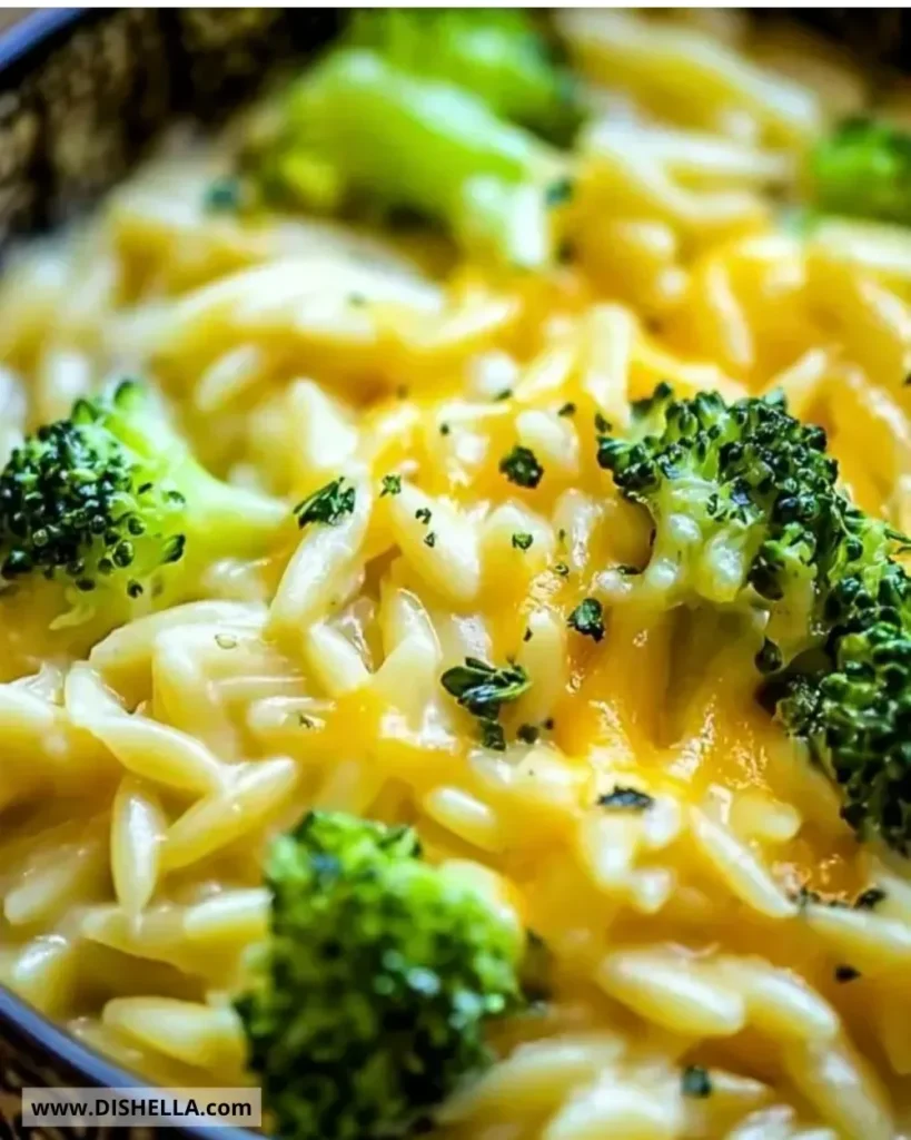 Creamy one-pot broccoli cheddar orzo in a bowl with fresh broccoli.