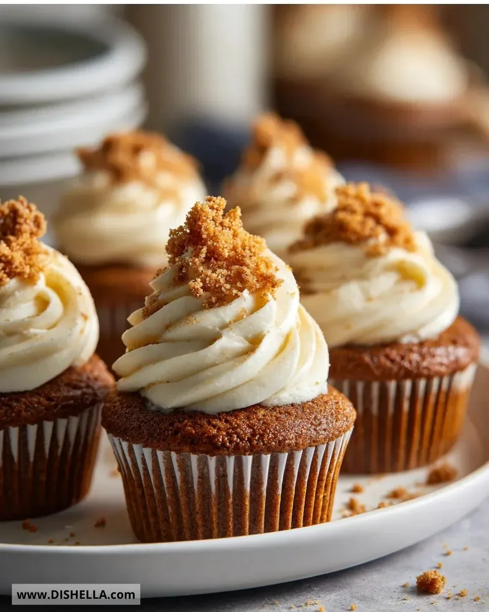 Easy gin gingerbread cupcakes topped with festive icing and gingerbread crumbs.