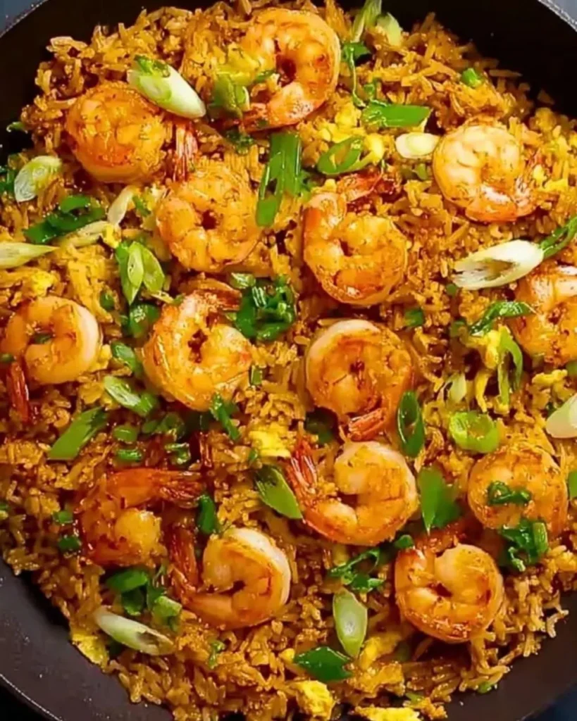 Plate of easy Thai shrimp fried rice garnished with vegetables and herbs.