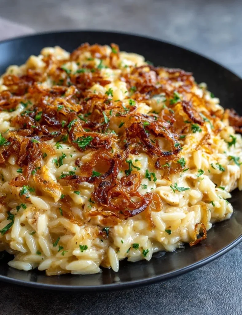 French Onion Chicken Orzo Casserole baked and garnished with herbs