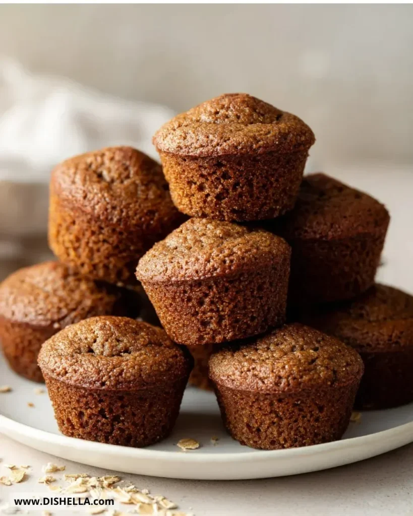 Gingerbread oat flour muffins fresh out of the oven on a wooden table