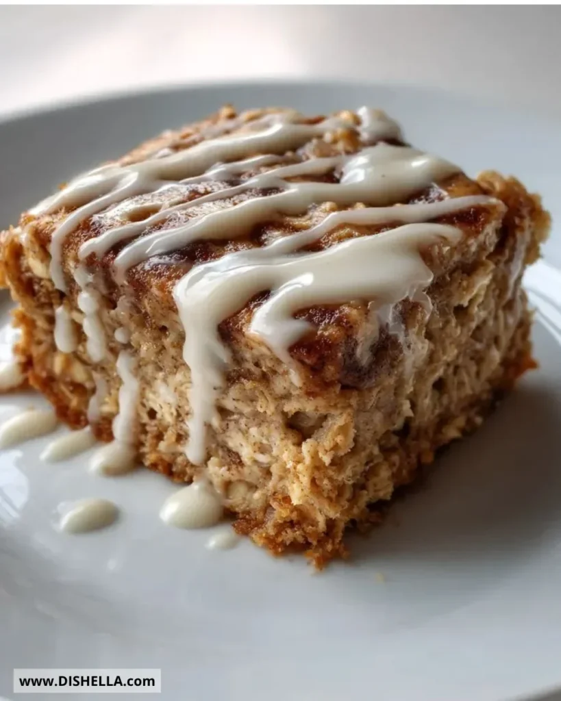 High-protein cinnamon roll baked oatmeal served in a bowl with cinnamon and nuts