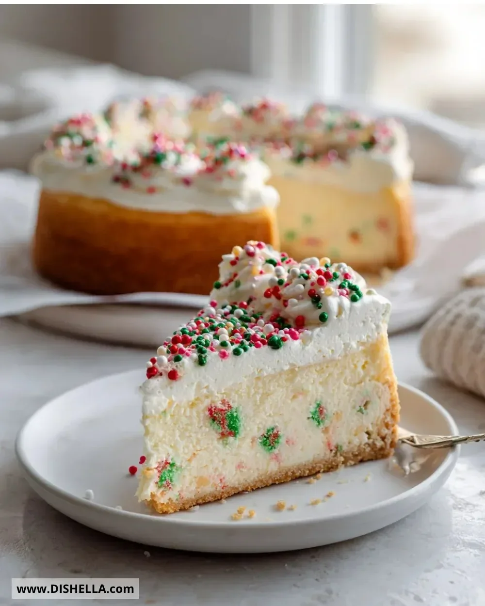 Slice of sugar cookie cheesecake dessert with colorful sprinkles on top.