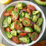 Delicious cucumber tomato avocado salad in a bowl