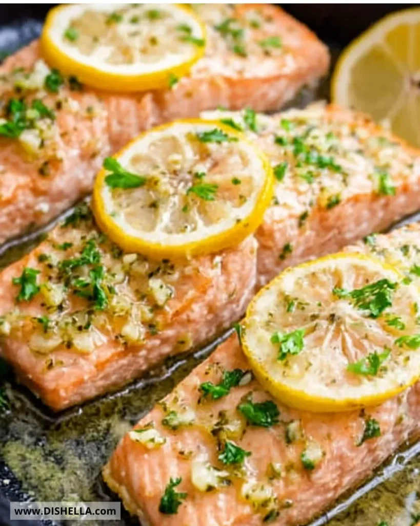 Easiest baked salmon topped with herbs and lemon on a plate