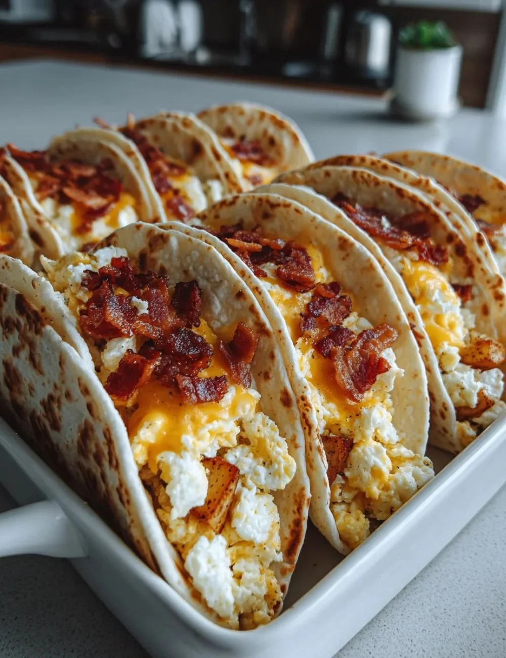 Easy baked breakfast tacos with bacon and cheese on a plate