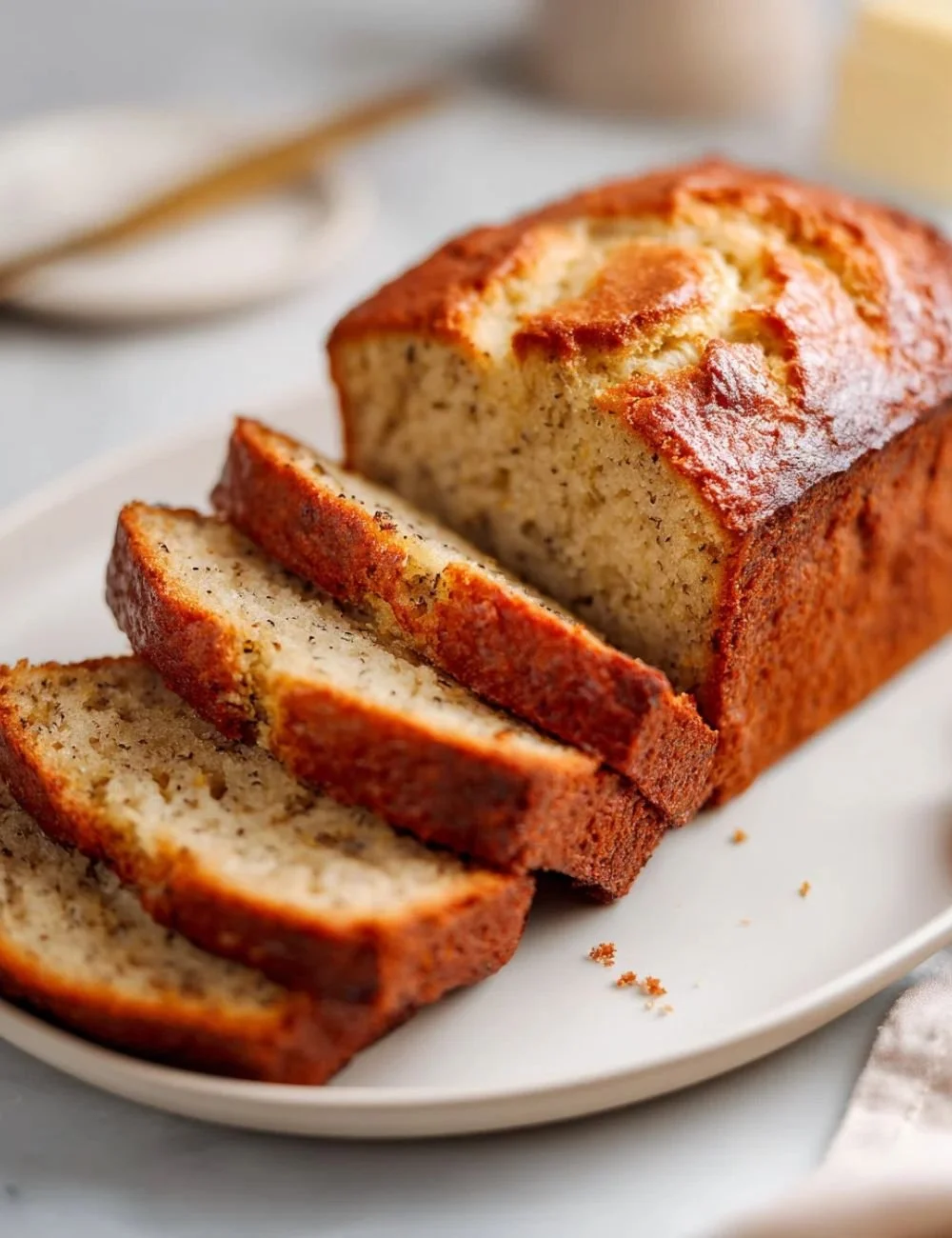 Slice of high protein banana bread on a wooden cutting board