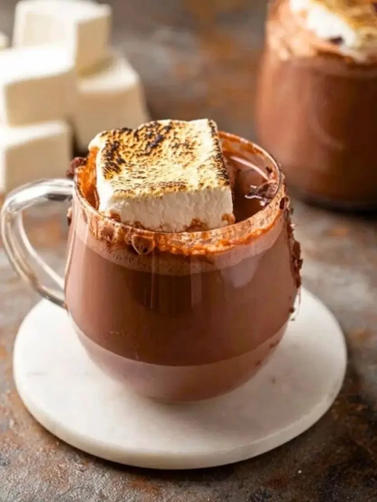 Crock pot filled with rich and creamy hot cocoa topped with marshmallows