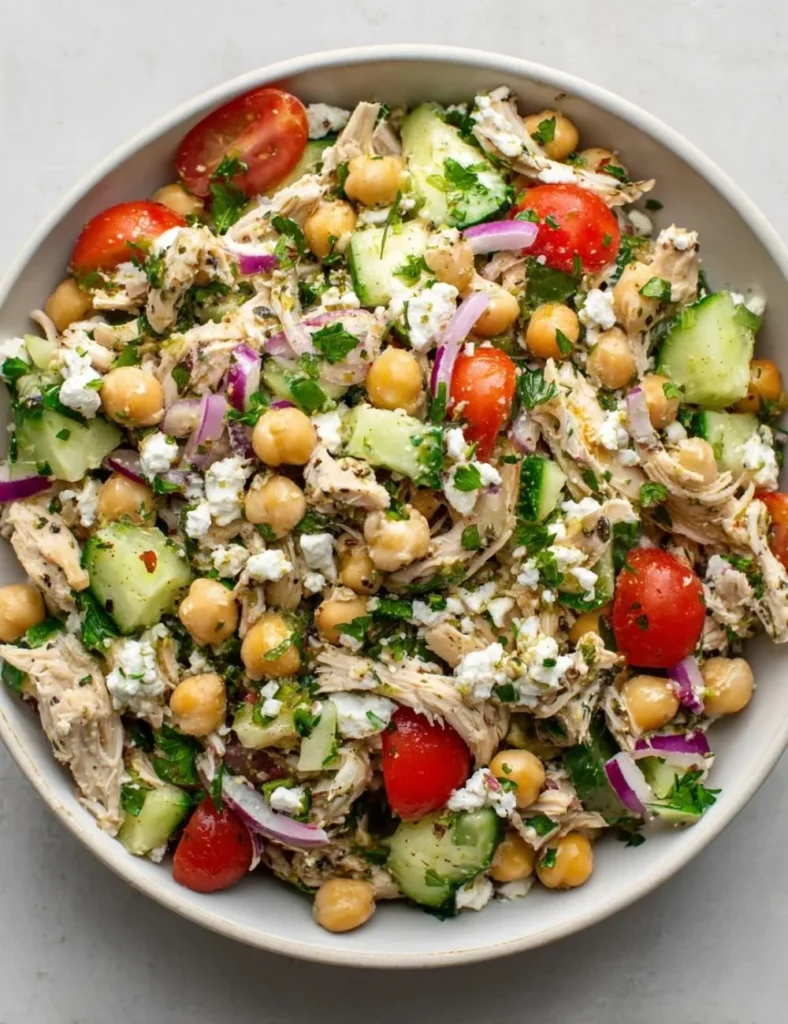 Chicken and chickpea salad with vibrant vegetables and a tasty dressing.