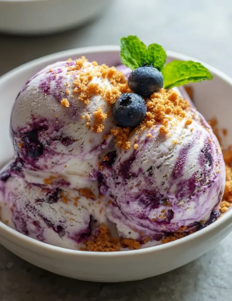 A bowl of homemade cottage cheese ice cream topped with fresh fruit.
