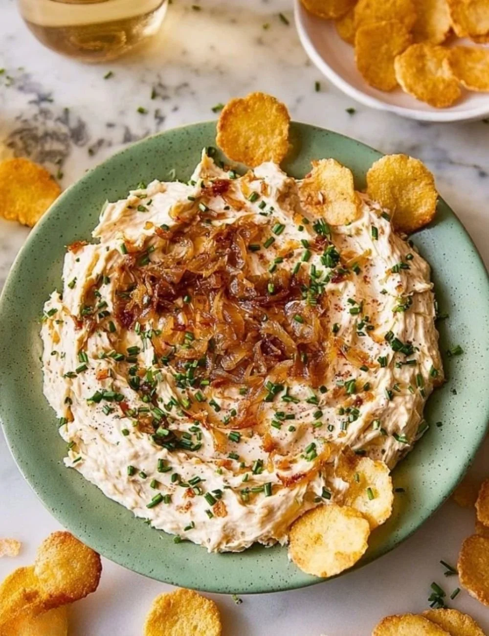 Delicious caramelized onion dip served with fresh veggies and chips