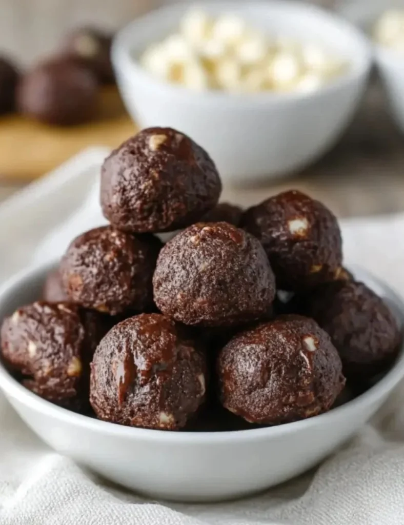 Fudgy cottage cheese brownie bites on a plate, offering a healthy dessert option.