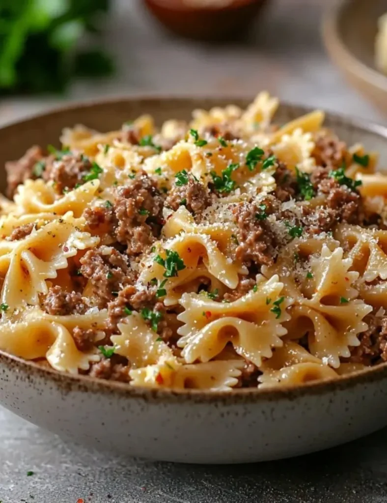 Delicious Garlic Butter Bowtie Pasta with tender beef garnished with herbs