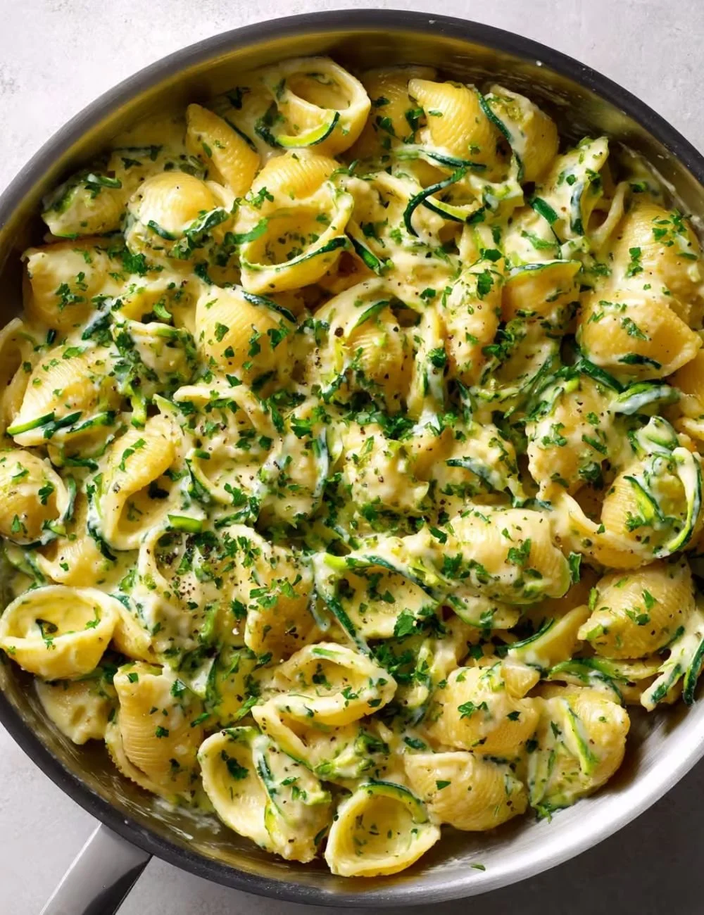 Homemade Italian zucchini sauce served with pasta on a plate.