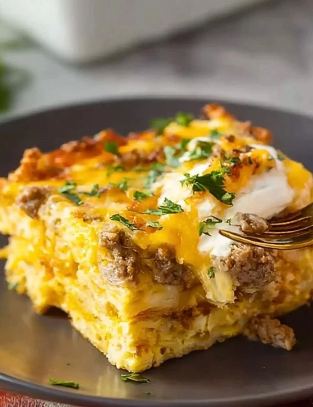 Cheesy Southwest Tortilla Breakfast Casserole topped with fresh herbs and spices.