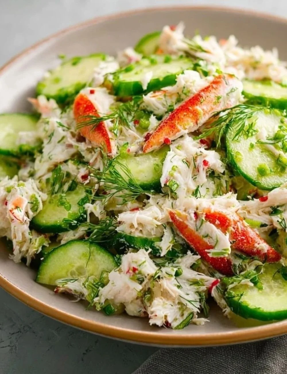 Chilled cucumber crab salad served with fresh herbs and garnishes