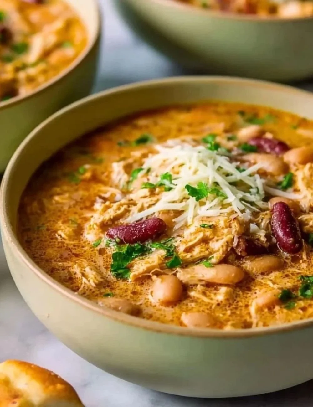 Bowl of hearty Cajun white chicken chili garnished with herbs
