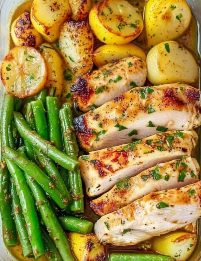 Lemon garlic chicken meal prep with fresh herbs and garnishes