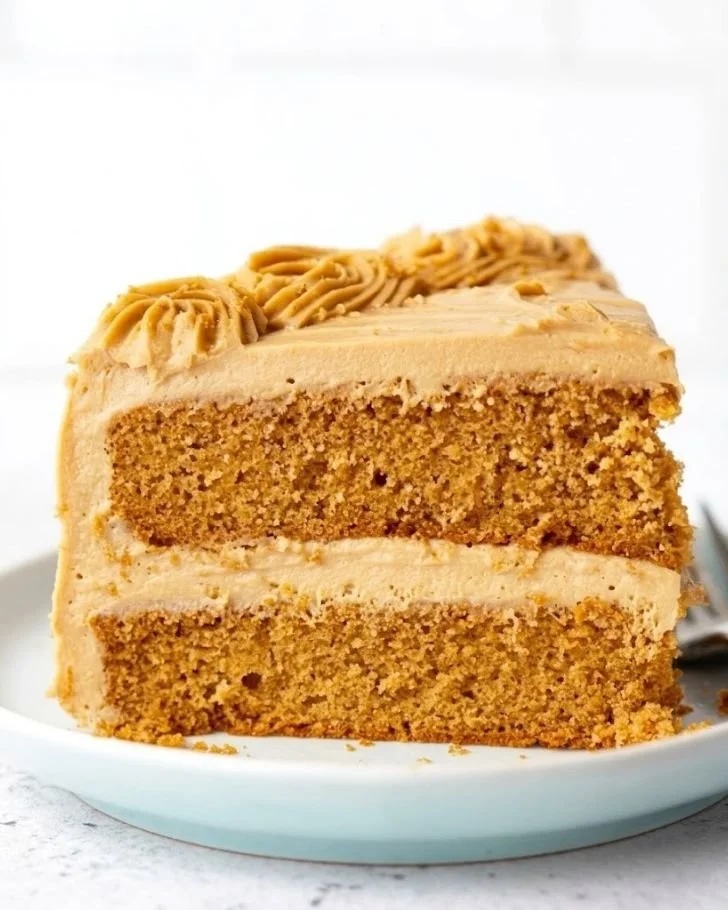 Decadent Biscoff Cake topped with creamy frosting and cookie crumbles