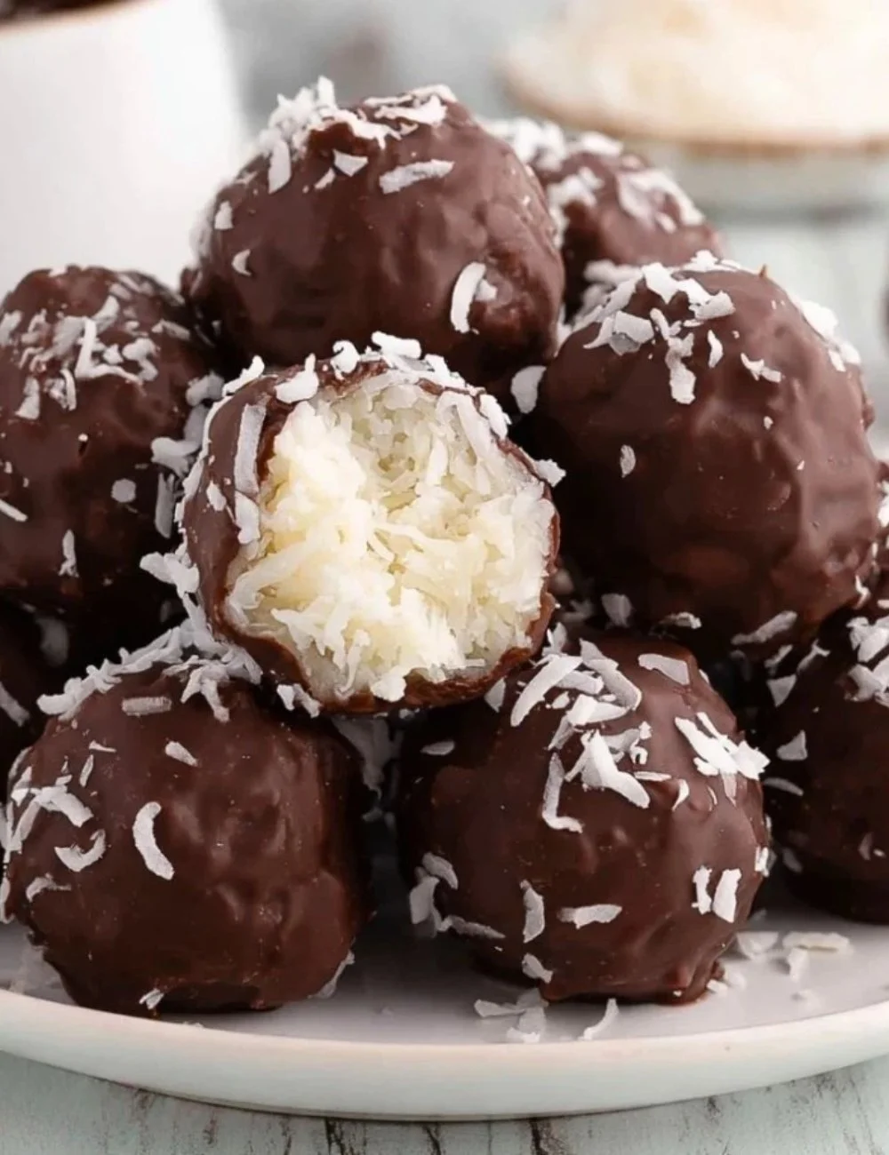 Delicious homemade coconut chocolate balls with a sprinkle of coconut flakes.