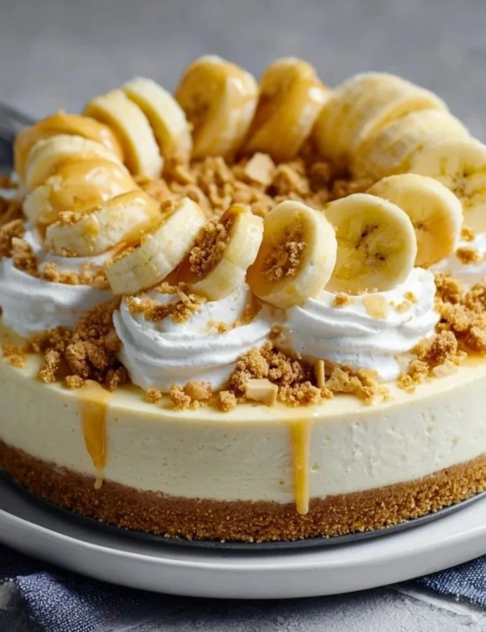 No-Bake Banana Pudding Cheesecake topped with banana slices and whipped cream