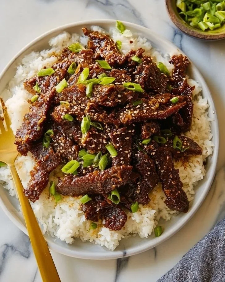 Delicious PF Chang's Mongolian Beef served with steamed rice and vegetables